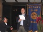 At the Escazu Club meeting, Cap Neilson gave a speech in Spanish.  This photo shows Cap giving the speech, with his friend Mario Gil sitting below him eagerly waiting to hear a mistake.